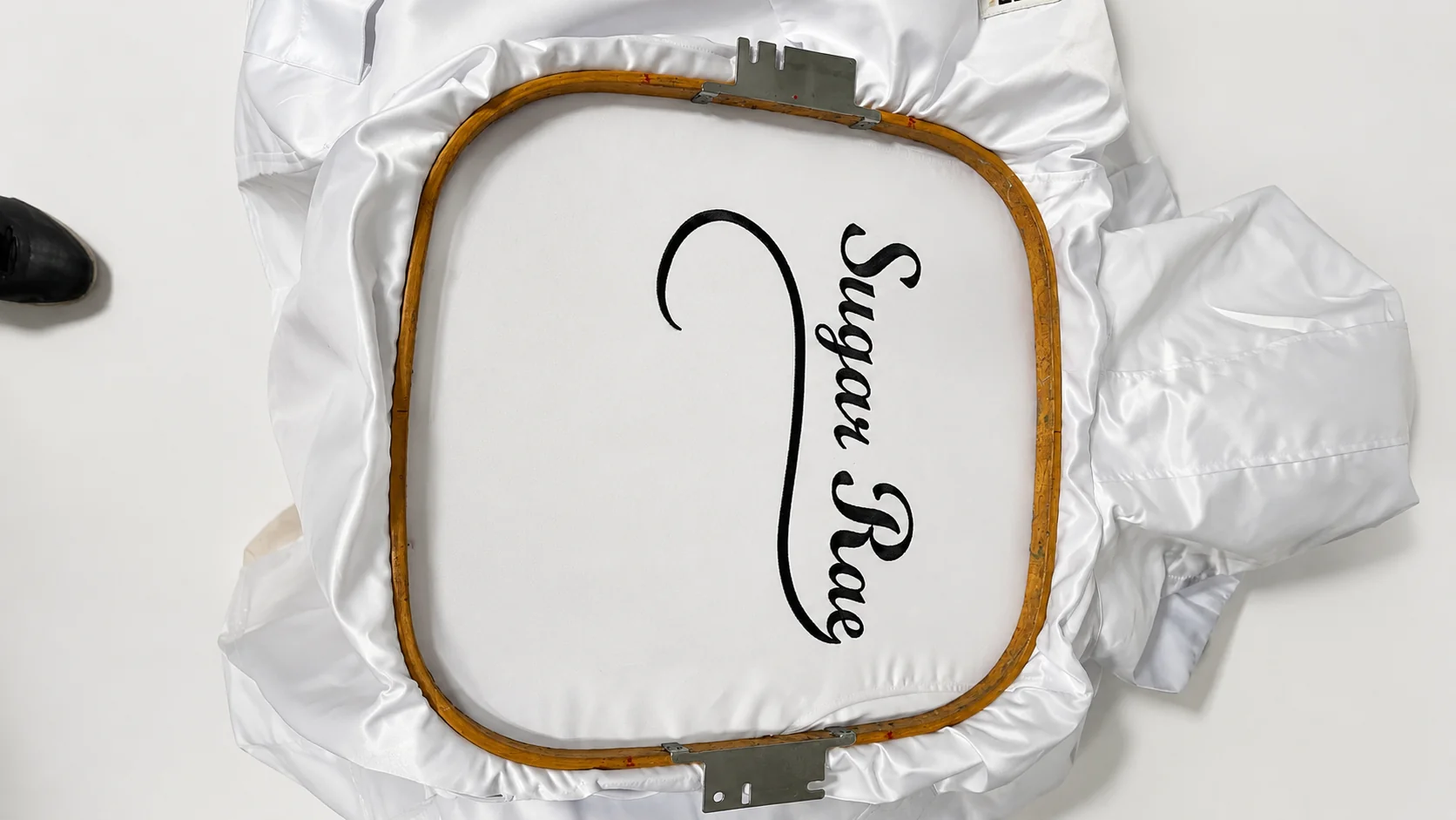 Hooped satin jacket embroidery with Sugar Rae script
